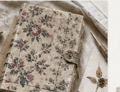 A floral fabric journal with a vintage button closure
